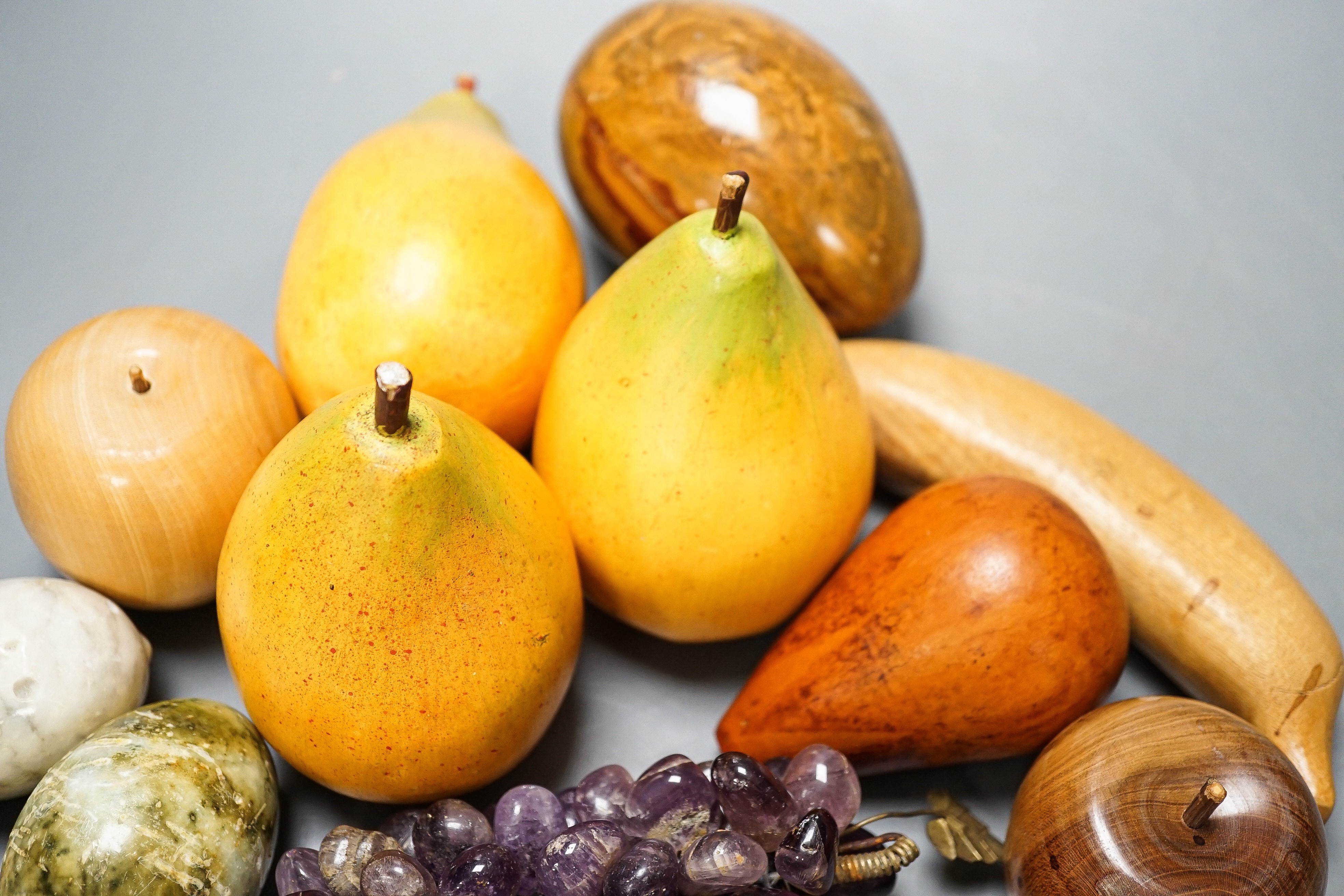 A group of polished stone and wood models of fruit, eggs, et.